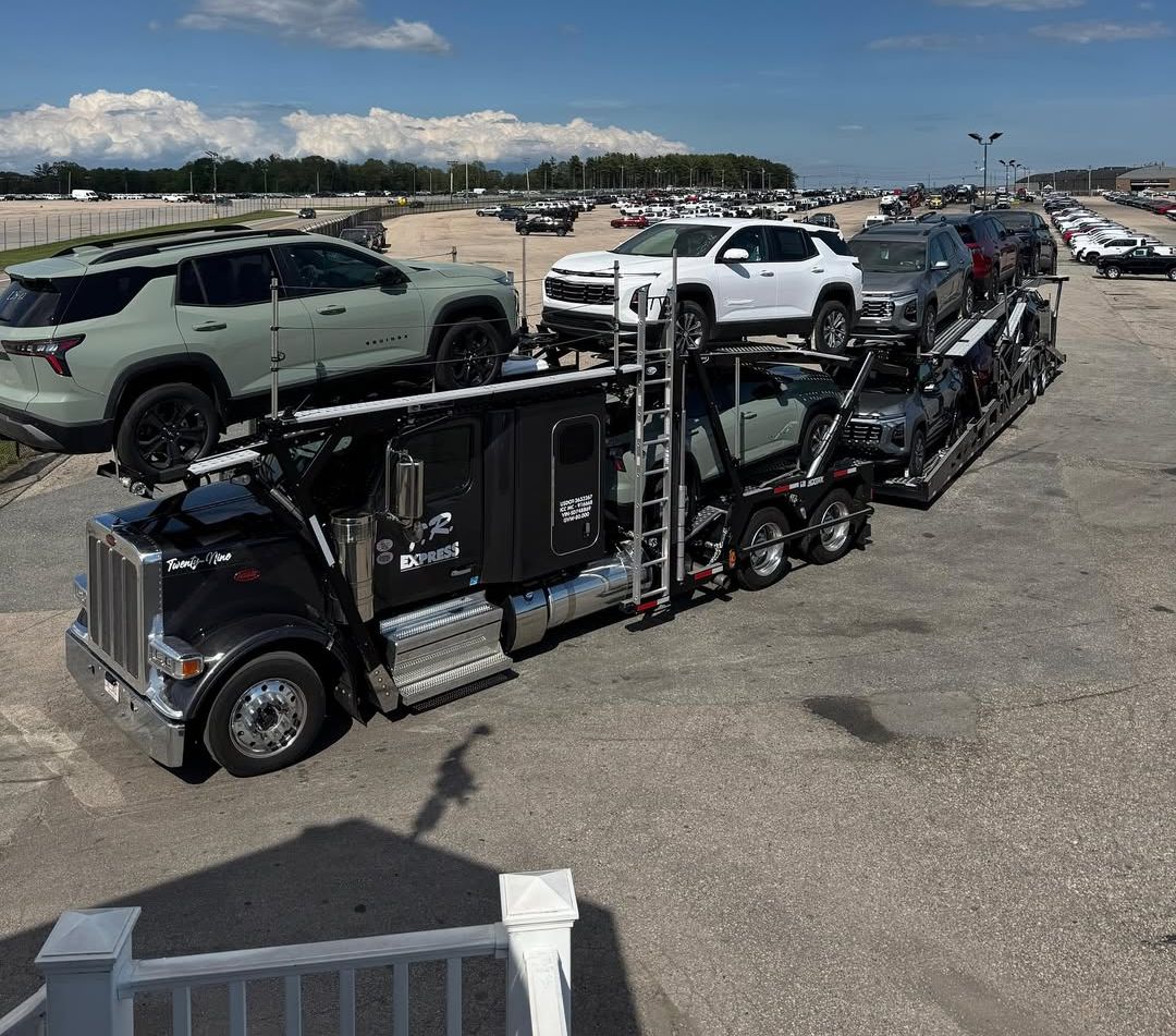Car carrier loading at a vehicle lot