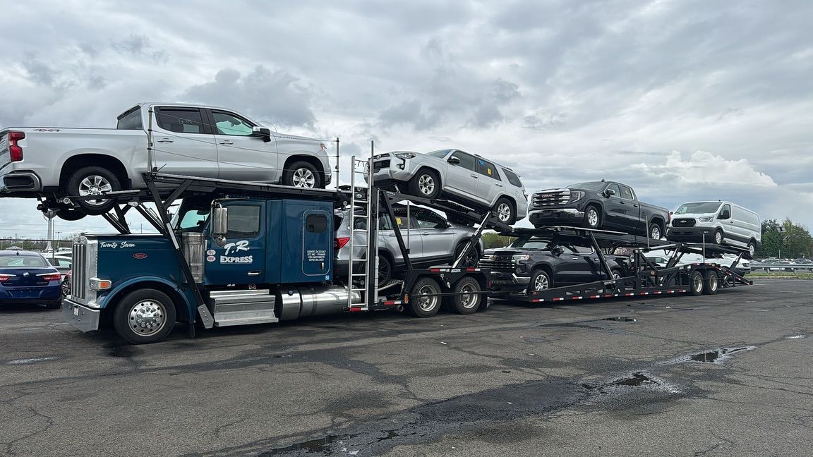 Car hauler loaded with pickups and SUVs