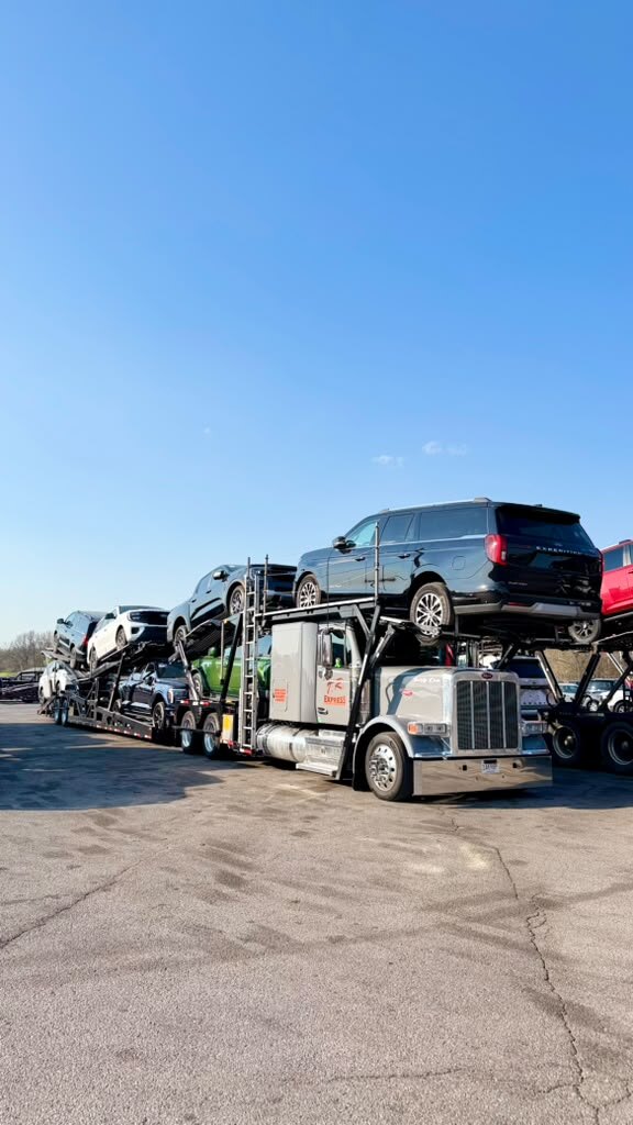 Car carrier loaded with SUVs on a sunny day